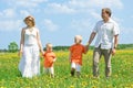 Happy family walking on meadow Royalty Free Stock Photo