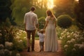 Happy family walking in the park at sunset., father and baby, rear view of Parents hold the baby\'s hands. Happy family in