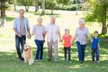 Happy family walking in the park with their dog Royalty Free Stock Photo