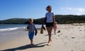 Happy family walking on sand beach sea resort relaxing together enjoying summer travel vacation Royalty Free Stock Photo