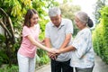 Happy family walking together in the garden. Old elderly using a walking stick to help walk balance. Concept of  Love and care of Royalty Free Stock Photo