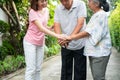 Happy family walking together in the garden. Old elderly using a walking stick to help walk balance. Concept of  Love and care of Royalty Free Stock Photo