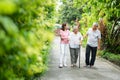 Happy family walking together in the garden. Old elderly using a walking stick to help walk balance. Concept of  Love and care of Royalty Free Stock Photo