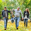Happy family walking together in a park Royalty Free Stock Photo