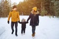 Happy family walking in winter day in forest Royalty Free Stock Photo