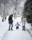 Happy family walking in winter park Royalty Free Stock Photo