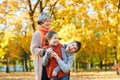 Happy family walks in autumn city park. Children and parents posing, smiling, playing and having fun. Bright yellow trees. Royalty Free Stock Photo
