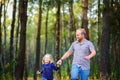 Happy family walks in the evening park, holding hands