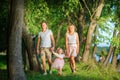 Happy family walks in a lakeside park