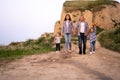 Happy family walks on nature mother father and daughters for a walk go along the road near the cliff. Weekend or summer Royalty Free Stock Photo