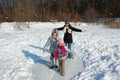 Happy family in winter, having fun and playing with snow outdoors on holiday weekend Royalty Free Stock Photo