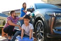 Happy family washing car at backyard Royalty Free Stock Photo