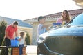 Happy family washing car at backyard