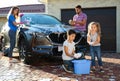 Happy family washing car at backyard