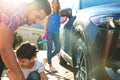 Happy family washing car at backyard Royalty Free Stock Photo