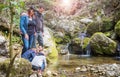 Happy family watch the mountain stream