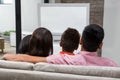 Happy family watching tv on the sofa