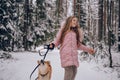 Happy family weekend - little cute girl in pink warm outwear walking having fun with red shiba inu dog in snowy white cold winter Royalty Free Stock Photo