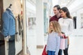 Happy family window shopping in mall Royalty Free Stock Photo