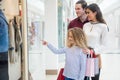 Happy family window shopping in mall Royalty Free Stock Photo