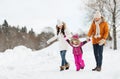 Happy family in winter clothes walking outdoors Royalty Free Stock Photo