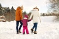 Happy family in winter clothes walking outdoors Royalty Free Stock Photo