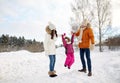 Happy family in winter clothes walking outdoors Royalty Free Stock Photo