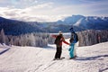 Happy family in winter clothing at the ski resort