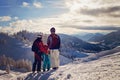 Happy family in winter clothing at the ski resort