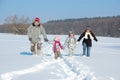 Happy family in winter, having fun and playing with snow outdoors on holiday weekend Royalty Free Stock Photo
