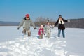 Happy family in winter, having fun and playing with snow outdoors on holiday weekend Royalty Free Stock Photo