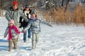 Happy family in winter, having fun with snow outdoors Royalty Free Stock Photo