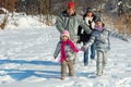 Happy family in winter, having fun with snow outdoors Royalty Free Stock Photo