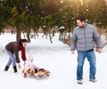 Happy family in winter park. Baby on the sled In the snow Royalty Free Stock Photo