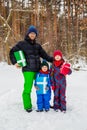Happy family in the winter snowy forest with gift boxes. Gifts from Santa Claus Royalty Free Stock Photo