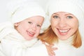 Happy family on a winter walk. Mother and baby daughter in the white hats Royalty Free Stock Photo