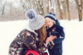 Happy family on a winter walk. Young mother and baby boy playing in snow. Frost winter snowy season. Happy child with mom enjoing Royalty Free Stock Photo
