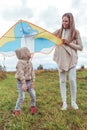 Happy family woman mom and little boy son fly kite, summer autumn day in field. Emotions of happiness, fun, joys of Royalty Free Stock Photo