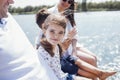 Happy family on wooden bridge against the backdrop of the sea or lake Royalty Free Stock Photo