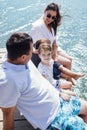 Happy family on wooden bridge against the backdrop of the sea or lake Royalty Free Stock Photo