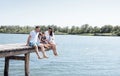 Happy family on wooden bridge against the backdrop of the sea or lake Royalty Free Stock Photo