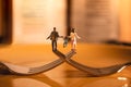 Happy Family and Work Life Balance Concept. Miniature of Father, Mother and Son holding Hands and Walking on the Fork Royalty Free Stock Photo