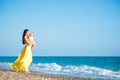 Happy family in a yellow dress. Mother and child are walking on the beach Royalty Free Stock Photo