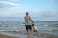 Happy family. Young beautiful father and his smiling son baby boy having fun on the beach of the sea, ocean. Positive human emotio Royalty Free Stock Photo