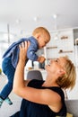 Happy family. Mother and baby daughter plays, hugging, kissing at home Royalty Free Stock Photo