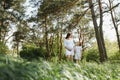 Happy family: a young beautiful pregnant woman with her little cute daughter on a sunny summer day. Parents and kids Royalty Free Stock Photo