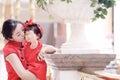 happy family young Chinese mother has fun with baby in China traditional cheongsam