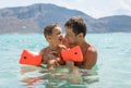 Happy family. Young father and his beautiful smiling son baby boy having fun on the beach of the sea, ocean. Positive human Royalty Free Stock Photo