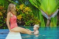 Happy family - young mother, baby son in swimming pool Royalty Free Stock Photo