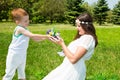 Happy family. Young mother and kid boy on sunny day. Portrait mom and son on nature. Positive human emotions, feelings, joy. Royalty Free Stock Photo